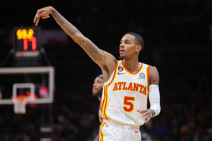 Hawks guard Dejounte Murray holds his form after making a shot.